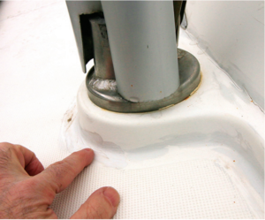 Finger pointing towards paint that has tried to cover up cracking