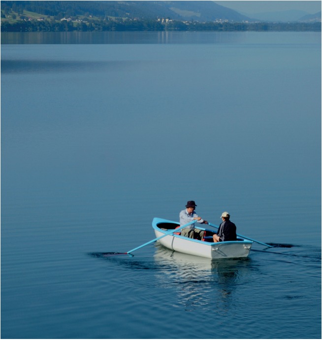 Two people in a wooden dinghy