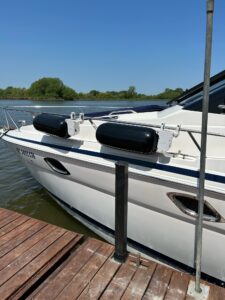 a boat with 2 fender systems installed next to boat fenders